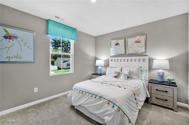 carpeted bedroom with baseboards and visible vents