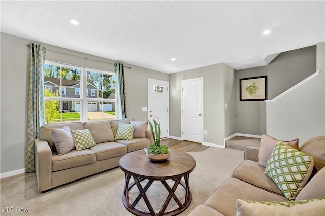living area featuring baseboards, light carpet, and recessed lighting