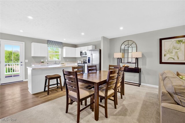 dining space featuring recessed lighting, baseboards, and light wood finished floors