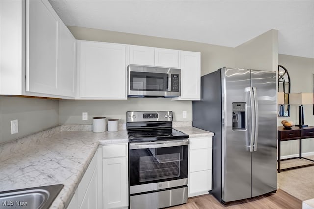 kitchen with light countertops, white cabinetry, and appliances with stainless steel finishes