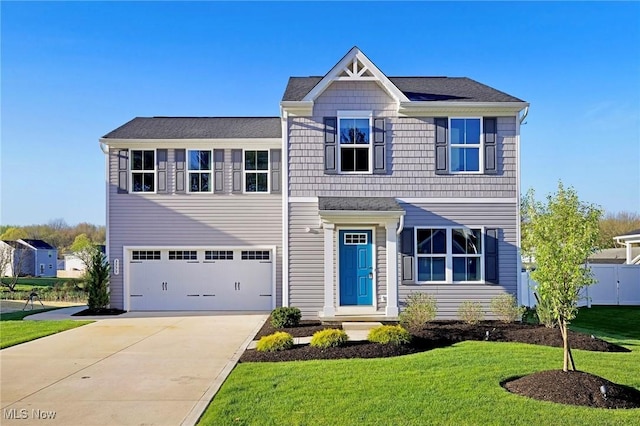 view of front of property featuring fence, an attached garage, driveway, and a front yard