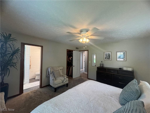bedroom featuring a ceiling fan, a textured ceiling, visible vents, connected bathroom, and carpet flooring