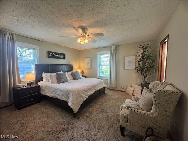 carpeted bedroom with ceiling fan and a textured ceiling