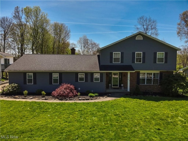 traditional home with a chimney and a front yard