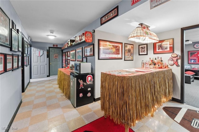 hallway featuring baseboards