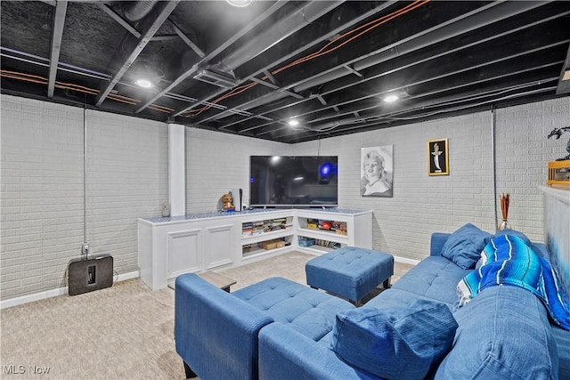 living room with carpet flooring and brick wall