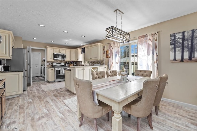 dining space with baseboards, recessed lighting, a textured ceiling, and light wood-style flooring