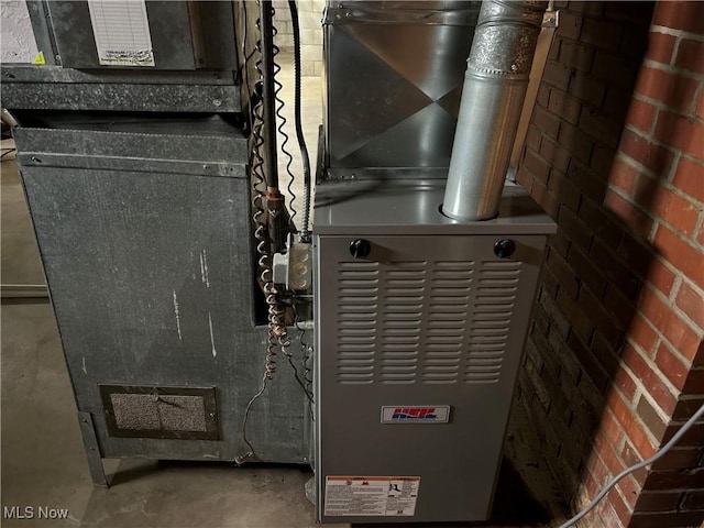 utility room featuring heating unit