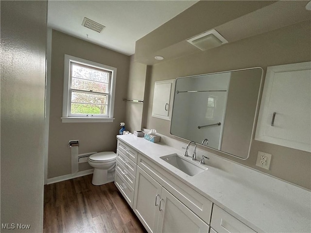 full bathroom featuring vanity, toilet, baseboards, wood finished floors, and visible vents
