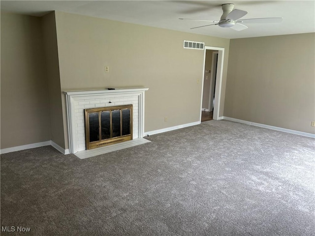 unfurnished living room featuring visible vents, a fireplace, baseboards, a ceiling fan, and carpet