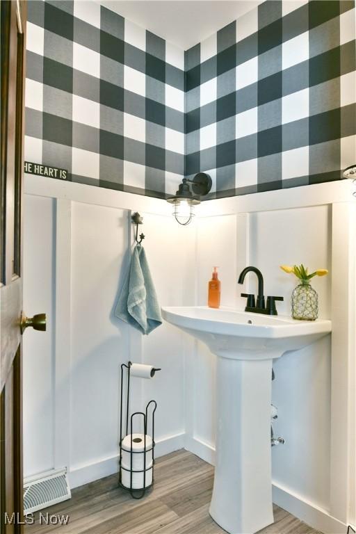 bathroom with visible vents and wood finished floors