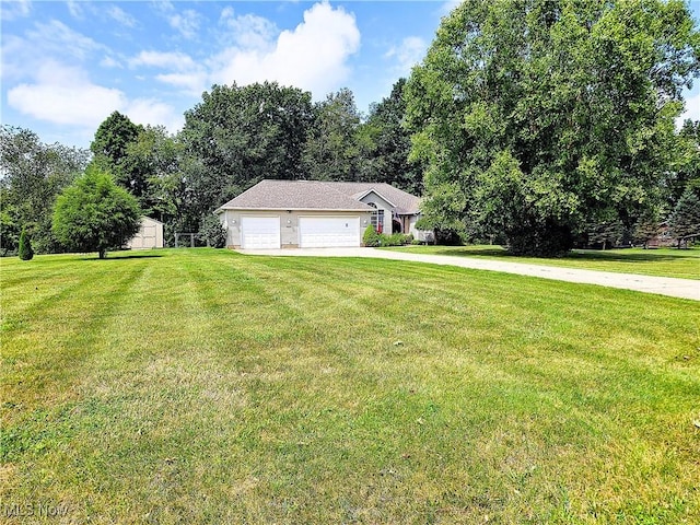 exterior space with a garage, driveway, and a front yard