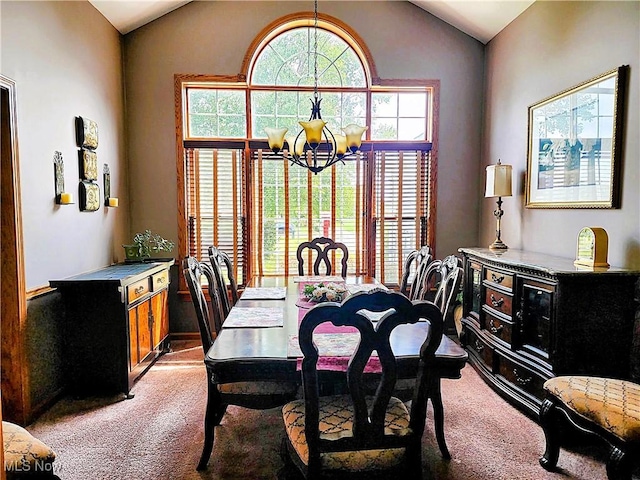 dining space with light colored carpet, a notable chandelier, and vaulted ceiling