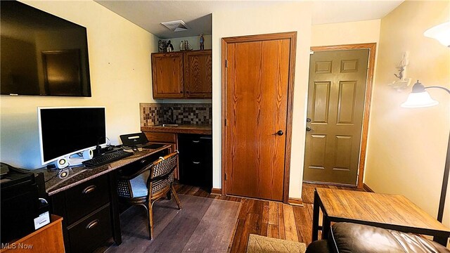 home office featuring visible vents and dark wood-type flooring