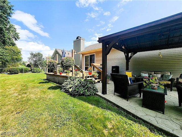 view of yard featuring a gazebo, outdoor lounge area, a wooden deck, and a patio area