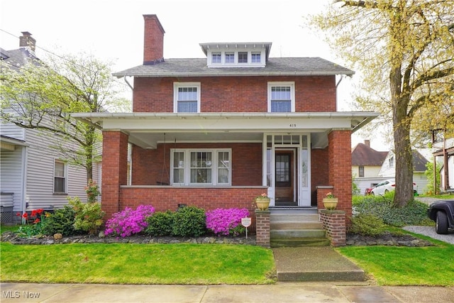 traditional style home with a porch, brick siding, and a chimney