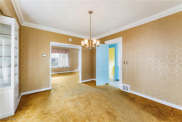 unfurnished dining area featuring carpet flooring, an inviting chandelier, baseboards, visible vents, and ornamental molding