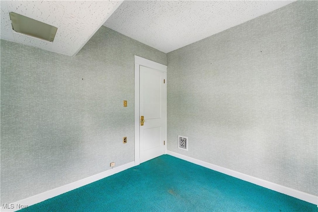 empty room featuring dark carpet and visible vents