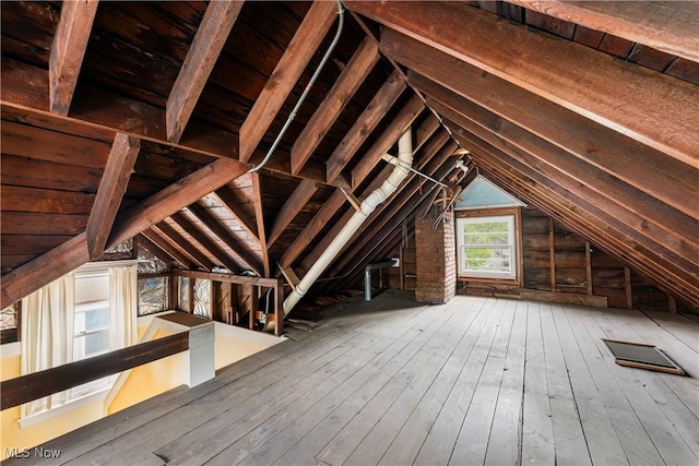 unfinished attic with an upstairs landing