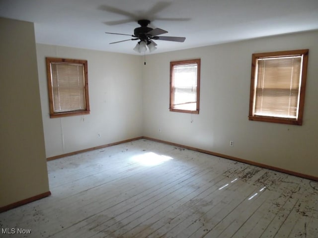unfurnished room with baseboards, ceiling fan, and hardwood / wood-style floors