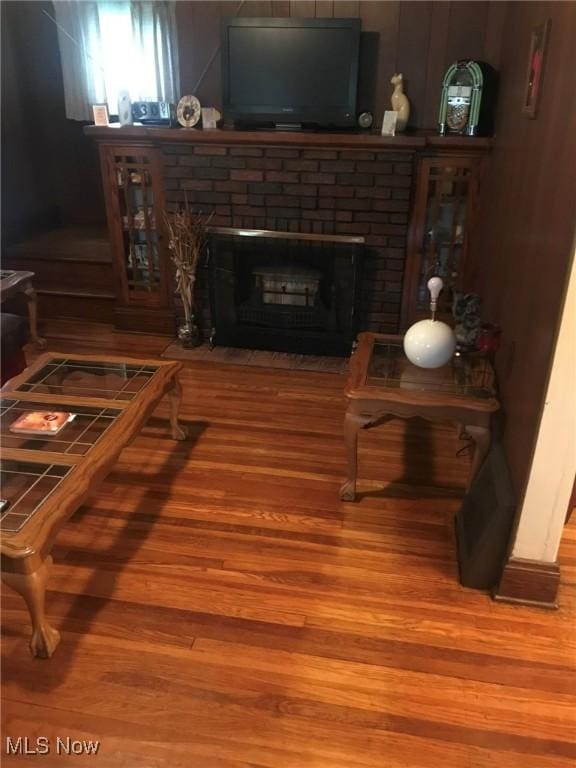 living area featuring wood finished floors and a fireplace