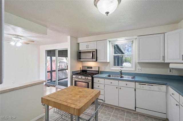 6414 Glenallen Ave, Solon, OH 44139 - kitchen with appliances with stainless steel finishes, a sink, white cabinets, a textured ceiling, and ceiling fan