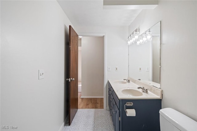 6414 Glenallen Ave, Solon, OH 44139 - bathroom featuring double vanity, toilet, and baseboards
