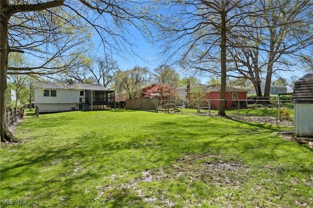 view of yard featuring a fenced backyard and a sunroom