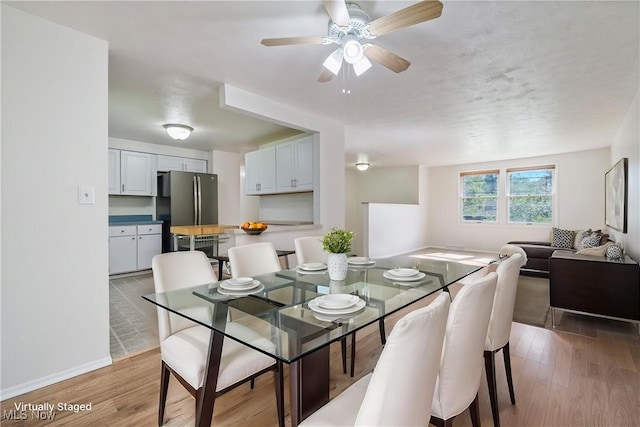 6414 Glenallen Ave, Solon, OH 44139 - dining room featuring light wood-style flooring, ceiling fan, and baseboards