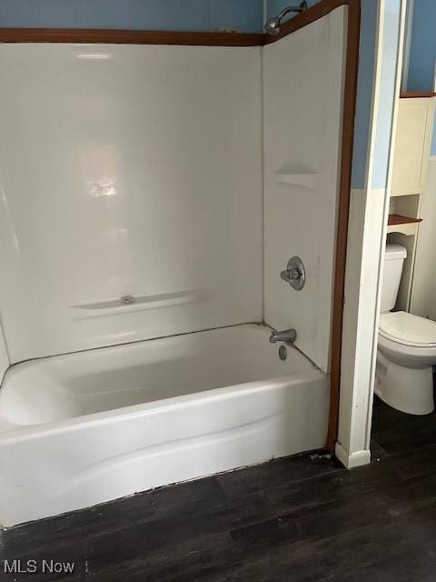 full bathroom with tub / shower combination, wood finished floors, and toilet
