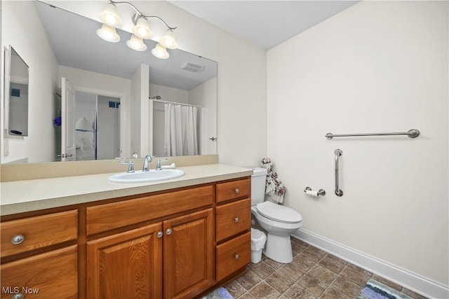 bathroom featuring visible vents, vanity, toilet, baseboards, and a shower with curtain