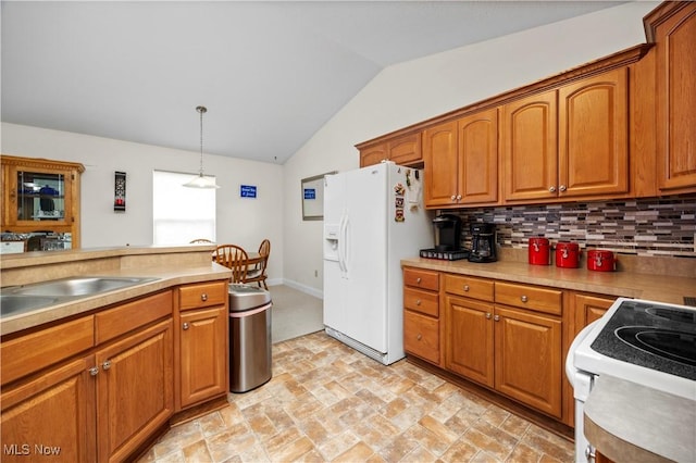 kitchen featuring tasteful backsplash, brown cabinetry, vaulted ceiling, and white appliances