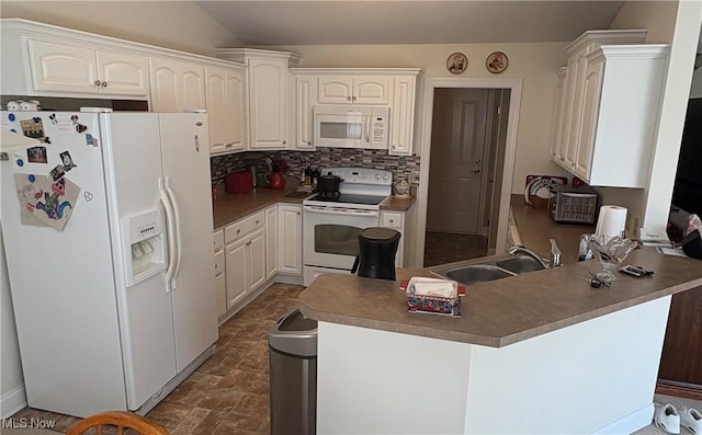 608 Chardonnay Cir, Vermilion, OH 44089 - kitchen with white appliances, a sink, a peninsula, backsplash, and stone finish flooring