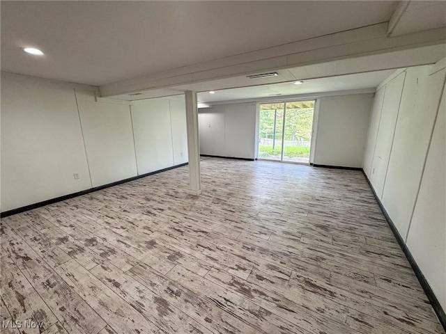 below grade area featuring recessed lighting, baseboards, wood finished floors, and visible vents