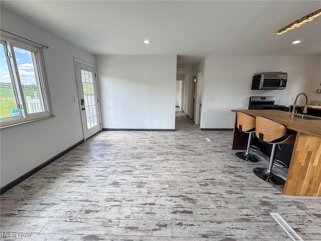 1160 Bethel Rd, Marietta, OH 45750 - interior space featuring wood finished floors, a sink, baseboards, stainless steel appliances, and recessed lighting