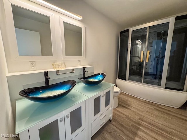 1160 Bethel Rd, Marietta, OH 45750 - bathroom with a sink, double vanity, toilet, and wood finished floors