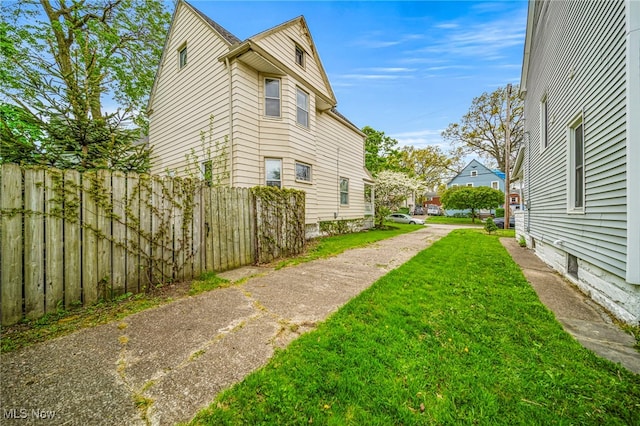 view of home's exterior featuring a yard and fence