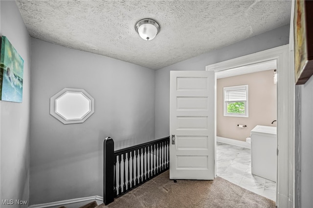 interior space featuring baseboards, a textured ceiling, and marble finish floor
