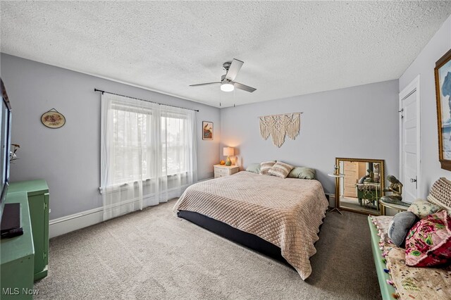 bedroom with carpet flooring, a textured ceiling, and a ceiling fan