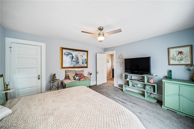 bedroom featuring baseboards, a ceiling fan, carpet flooring, and a textured ceiling