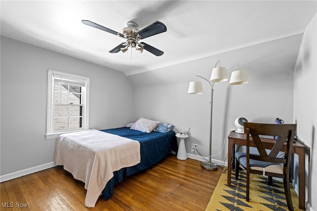 bedroom with wood-type flooring, a ceiling fan, and baseboards