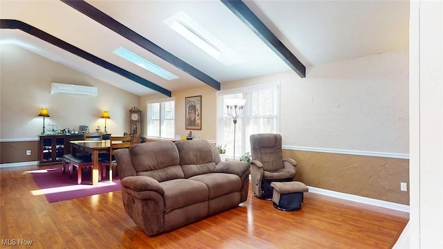 431 Somerset Dr, Chagrin Falls, OH 44022 - living area with vaulted ceiling with skylight, baseboards, a wall mounted air conditioner, and wood finished floors