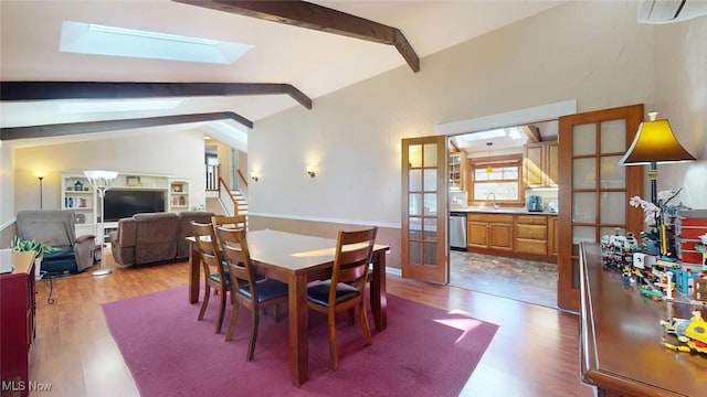 431 Somerset Dr, Chagrin Falls, OH 44022 - dining space with stairs, wood finished floors, and vaulted ceiling with skylight