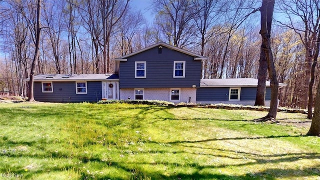 431 Somerset Dr, Chagrin Falls, OH 44022 - rear view of house with a lawn and brick siding