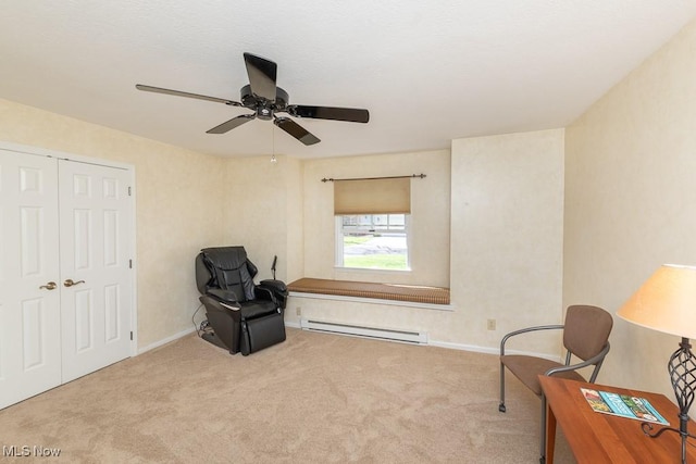 living area featuring baseboards, ceiling fan, a baseboard heating unit, and carpet flooring
