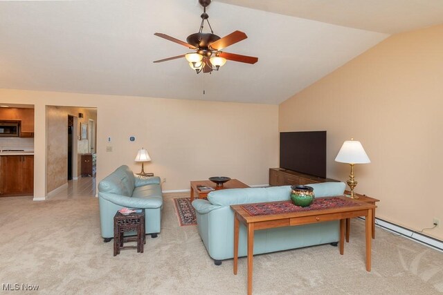 living room with light colored carpet, a ceiling fan, a baseboard heating unit, and vaulted ceiling