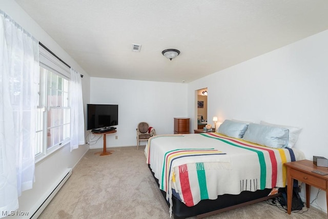 bedroom featuring carpet floors, visible vents, and a baseboard radiator