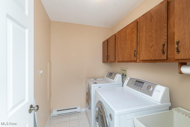 laundry area featuring a sink, separate washer and dryer, a baseboard radiator, cabinet space, and light tile patterned floors