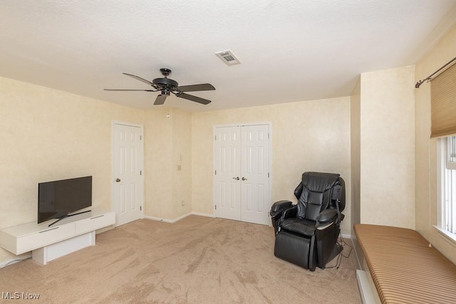 unfurnished room with visible vents, baseboards, ceiling fan, and light carpet