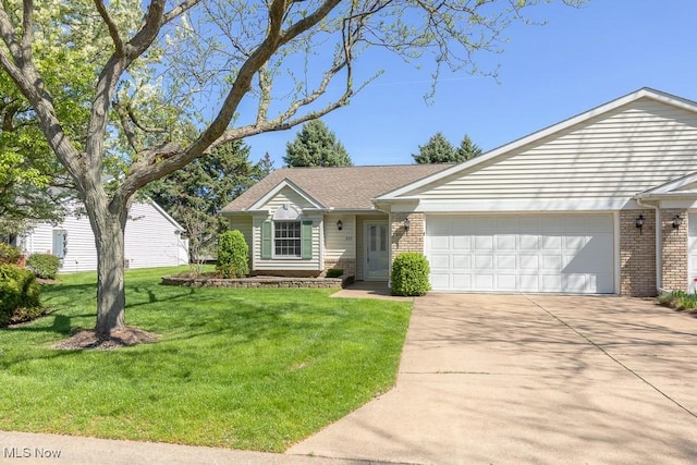 ranch-style house with brick siding, a garage, a front yard, and concrete driveway